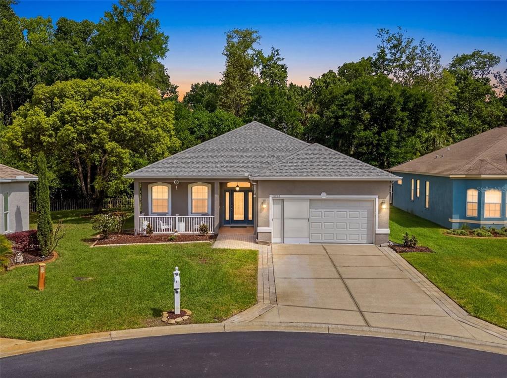 A single-story suburban house with a gray exterior, a two-car garage, and a front porch — 11303 CLEAR OAK CIRCLE, NEW PORT RICHEY, FL