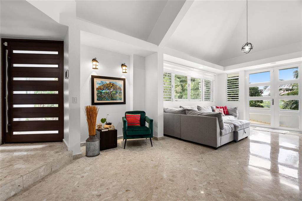 A living room with marble floors, a green armchair, and a gray sectional sofa — 19 CALLE "E", GUAYNABO, PR