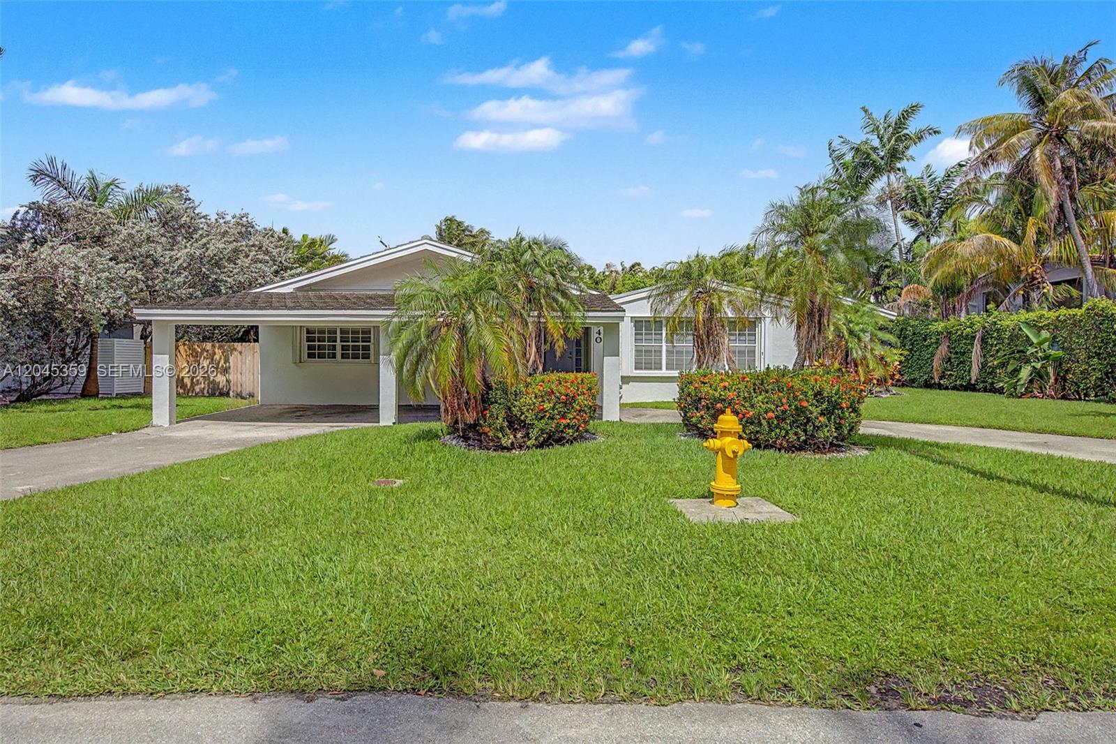 A single-story house with a carport, a front lawn, and a yellow fire hydrant — 340 Atlantic Rd, Key Biscayne FL 33149, KEY BISCAYNE, FL
