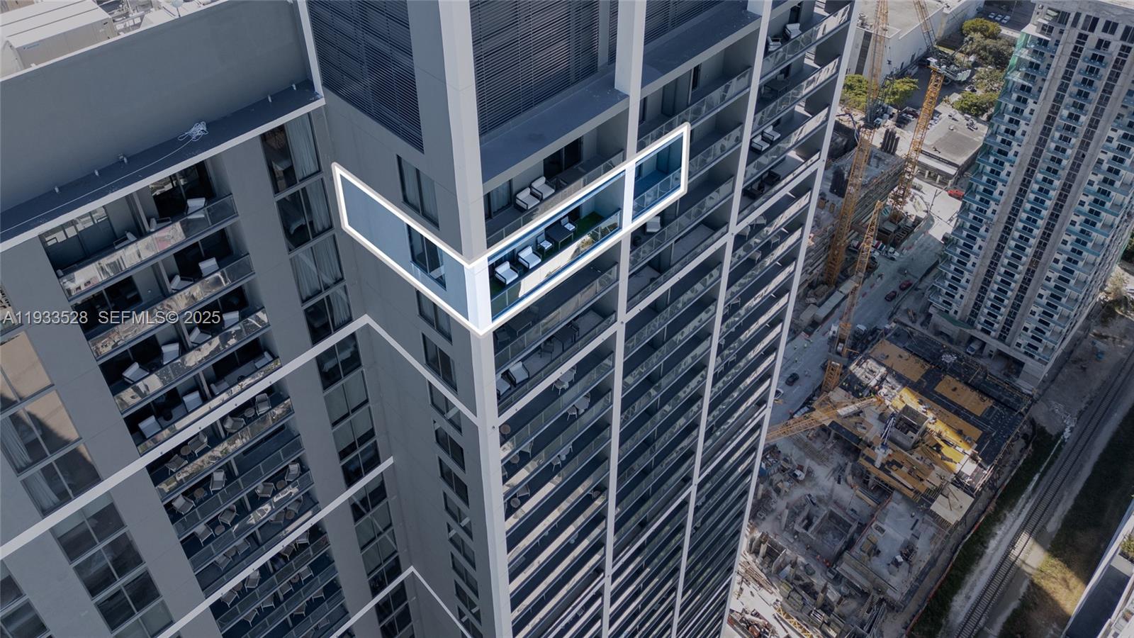 An aerial view shows a high-rise building with a highlighted corner balcony and surrounding construction — 601 NE 1St Ave, Miami FL 33132, MIAMI, FL