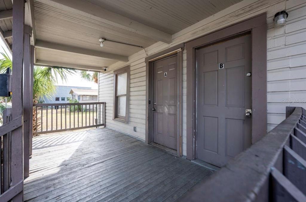 A wooden porch features two separate entrance doors labeled A and B — 1701 14TH AVENUE S UNIT A, ST PETERSBURG, FL