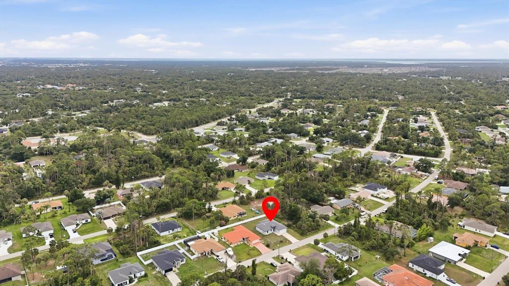 An aerial view shows a residential neighborhood with a red pin marking a specific house — 4746 GLOBE TERRACE, NORTH PORT, FL