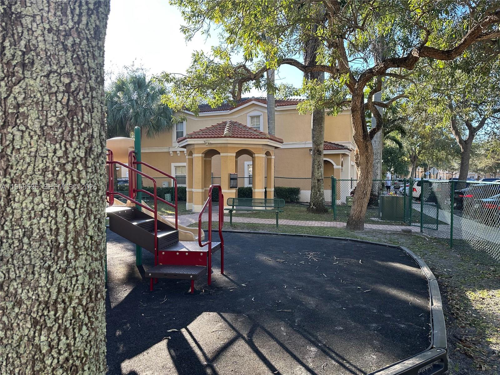 A playground with a slide and a gazebo sits in front of a residential building — 12811 SW 30th St # 110, Miramar FL 33027, MIRAMAR, FL