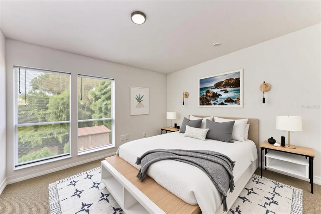 A bedroom features a queen bed, two nightstands, a patterned rug, and large windows — 3411 CLARK ROAD UNIT 212, SARASOTA, FL