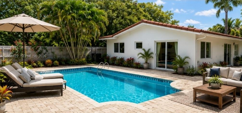 A backyard features a rectangular swimming pool, lounge chairs, and a patio next to a house — 141 NE 30th St, Wilton Manors FL 33334, WILTON MANORS, FL