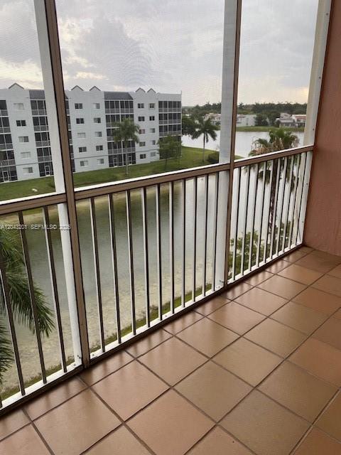 A multi-story apartment building with palm trees and a parking lot in the foreground — 10720 NW 66th ST # 503, Doral FL 33178, DORAL, FL