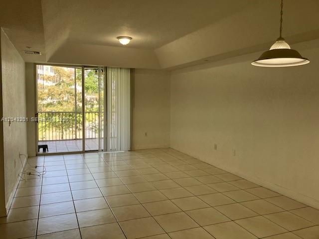 A kitchen features white cabinets, granite countertops, and stainless steel appliances — 10720 NW 66th ST # 503, Doral FL 33178, DORAL, FL