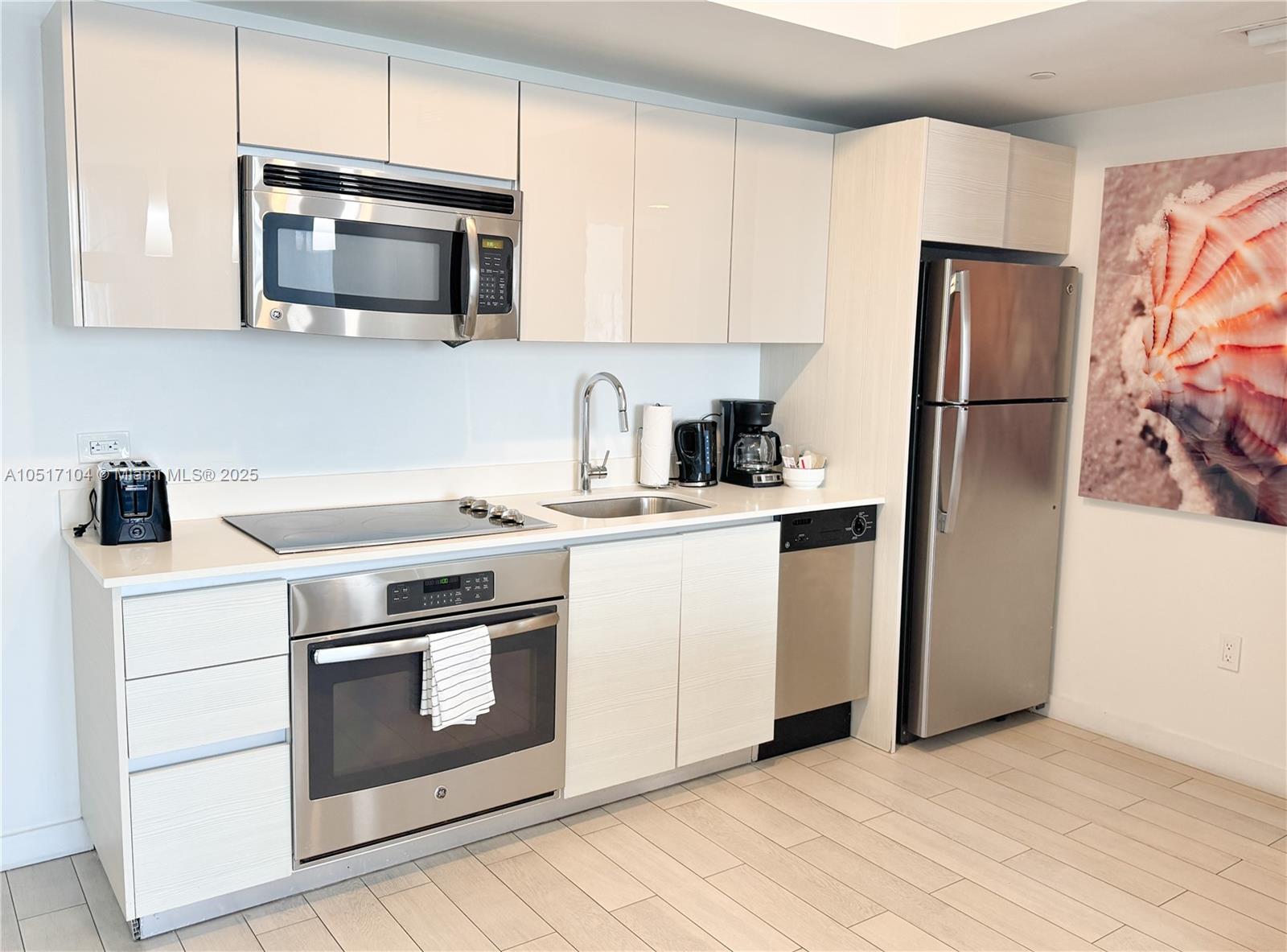 A modern kitchen features stainless steel appliances, light-colored cabinetry, and a white countertop — 2602 E Hallandale Beach Blvd # 1708, Hallandale Beach FL 33009, HALLANDALE BEACH, FL