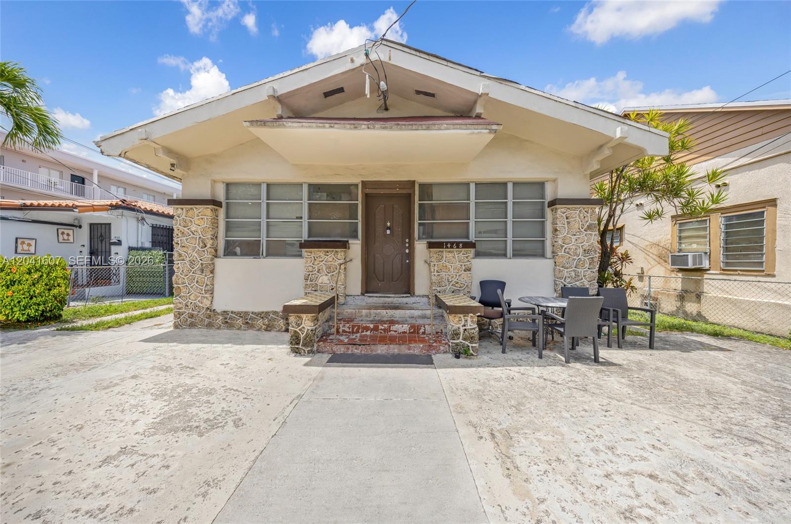 A single-story house features a stone-accented facade, a front porch, and a concrete driveway — 1468 SW 2nd St, Miami FL 33135, MIAMI, FL