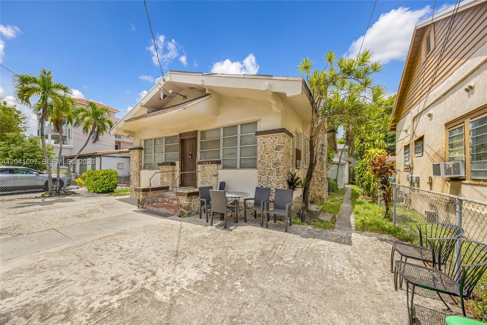 A single-story house features a stone facade, a front porch, and a concrete driveway — 1468 SW 2nd St, Miami FL 33135, MIAMI, FL
