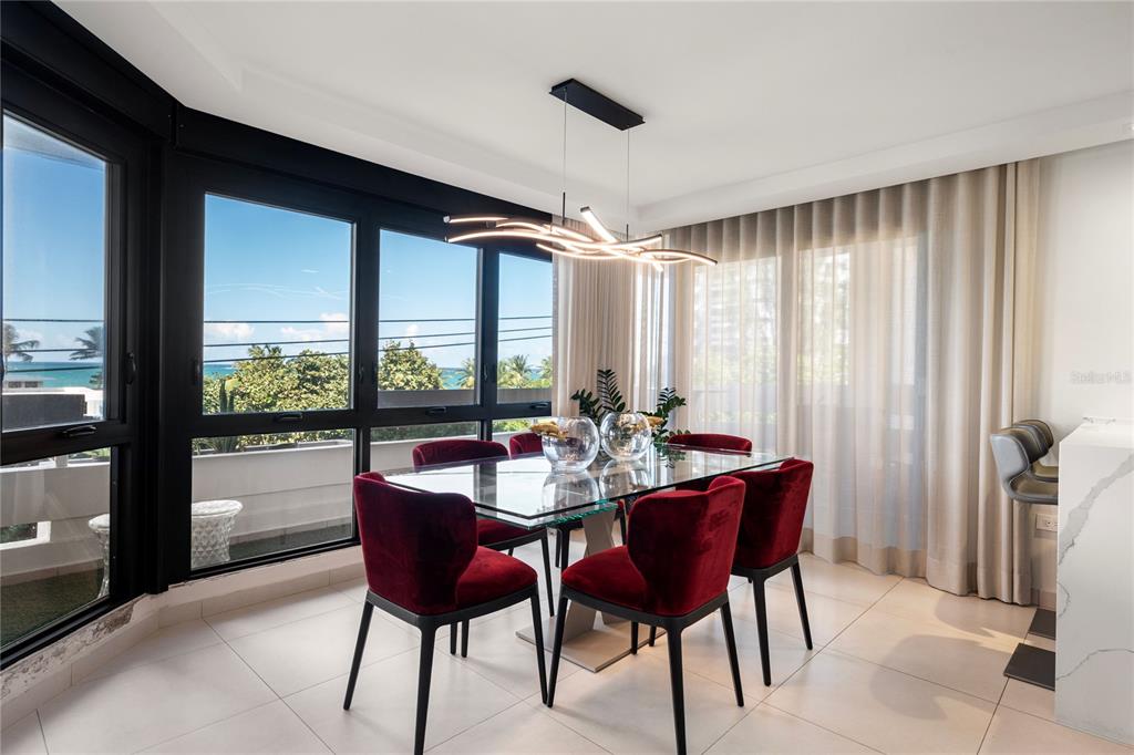 A modern living room features a sectional sofa, a patterned rug, and a large mirror — 1510 ASHFORD AVENUE UNIT 3, SAN JUAN, PR