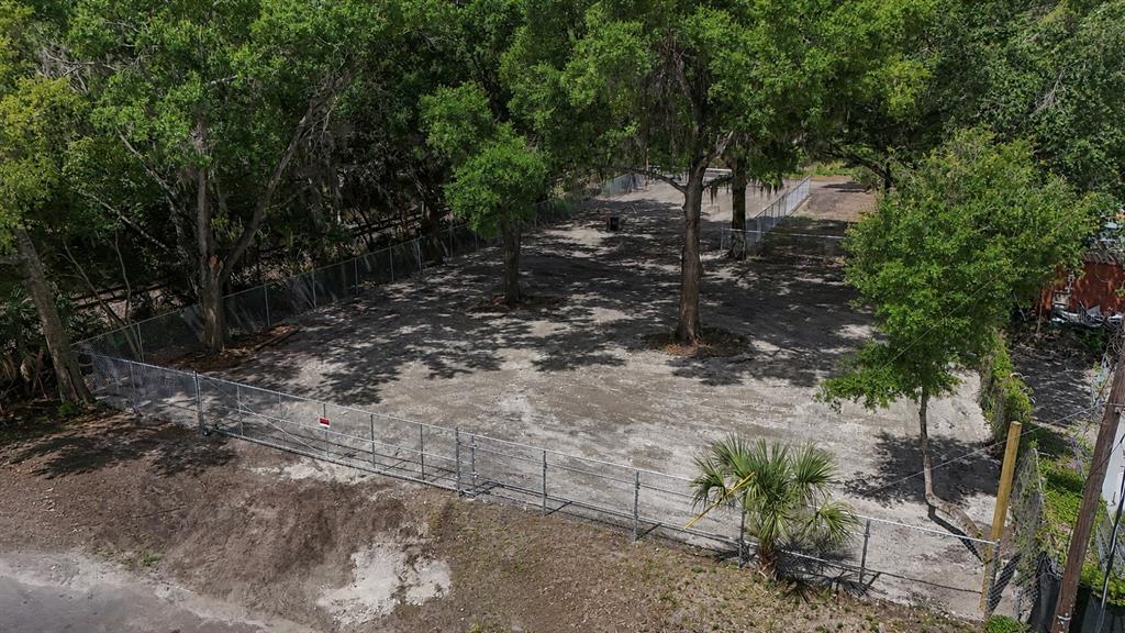 An aerial view shows a fenced, cleared dirt lot with several mature trees — 208 S FRANKLIN STREET, PLANT CITY, FL