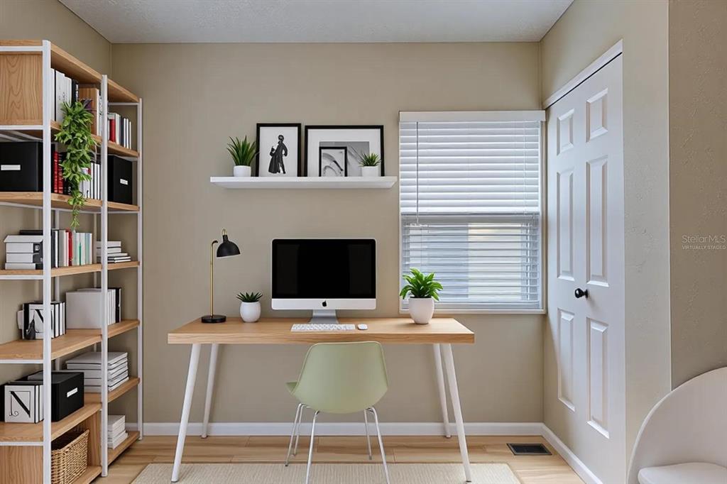 This is a virtually staged home office featuring a desk, shelving unit, and a window — 3408 PHILLIPS STREET, TAMPA, FL