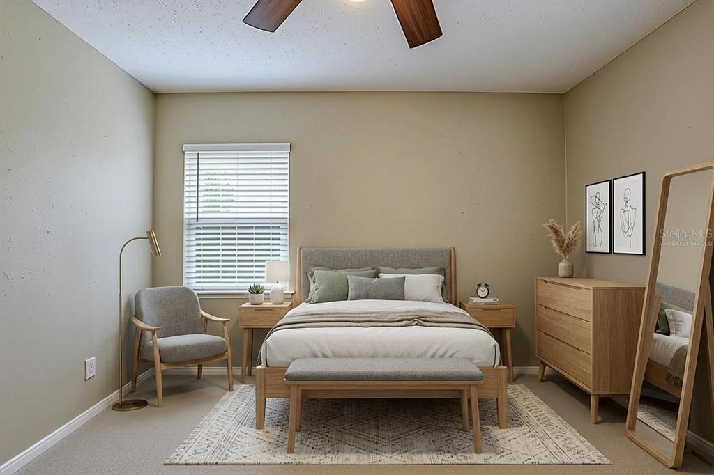 This virtually staged bedroom features a bed, a bench, a dresser, and a floor lamp — 3408 PHILLIPS STREET, TAMPA, FL