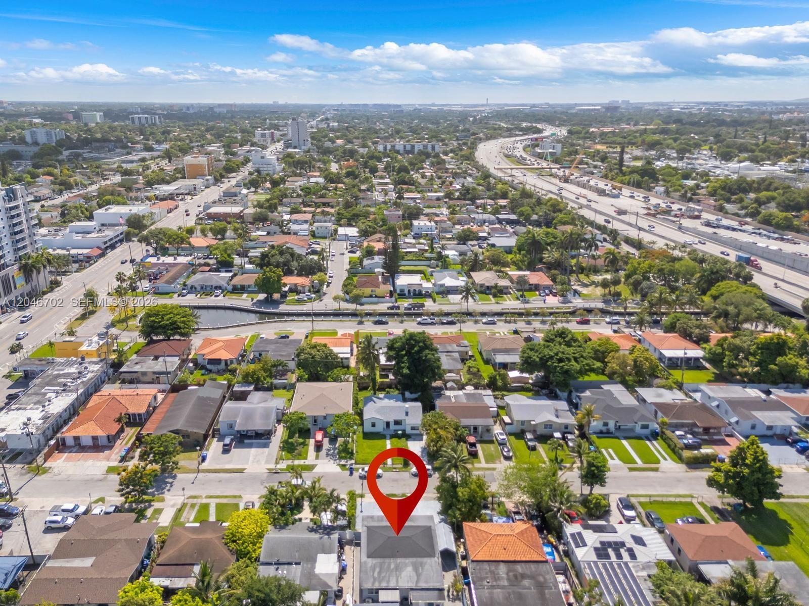 An aerial view shows a residential neighborhood with a red location pin over a house — 801 NW 17th Ct, Miami FL 33125, MIAMI, FL