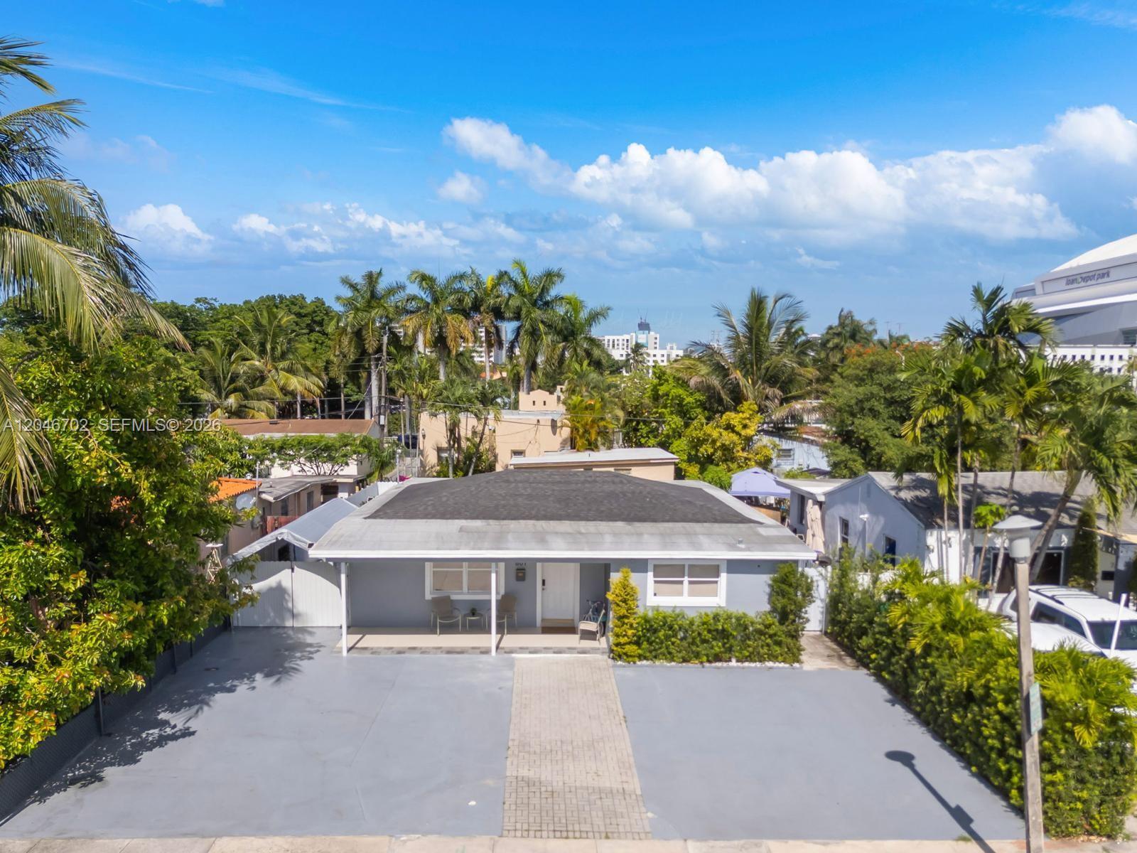 A single-story gray house with a paved driveway and a front porch under a roof — 801 NW 17th Ct, Miami FL 33125, MIAMI, FL