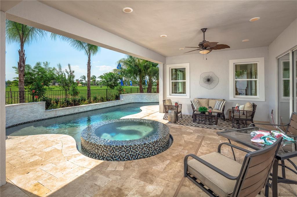 A covered patio features a pool, a tiled hot tub, and outdoor furniture — 2454 DREAM HOME COURT, ST CLOUD, FL