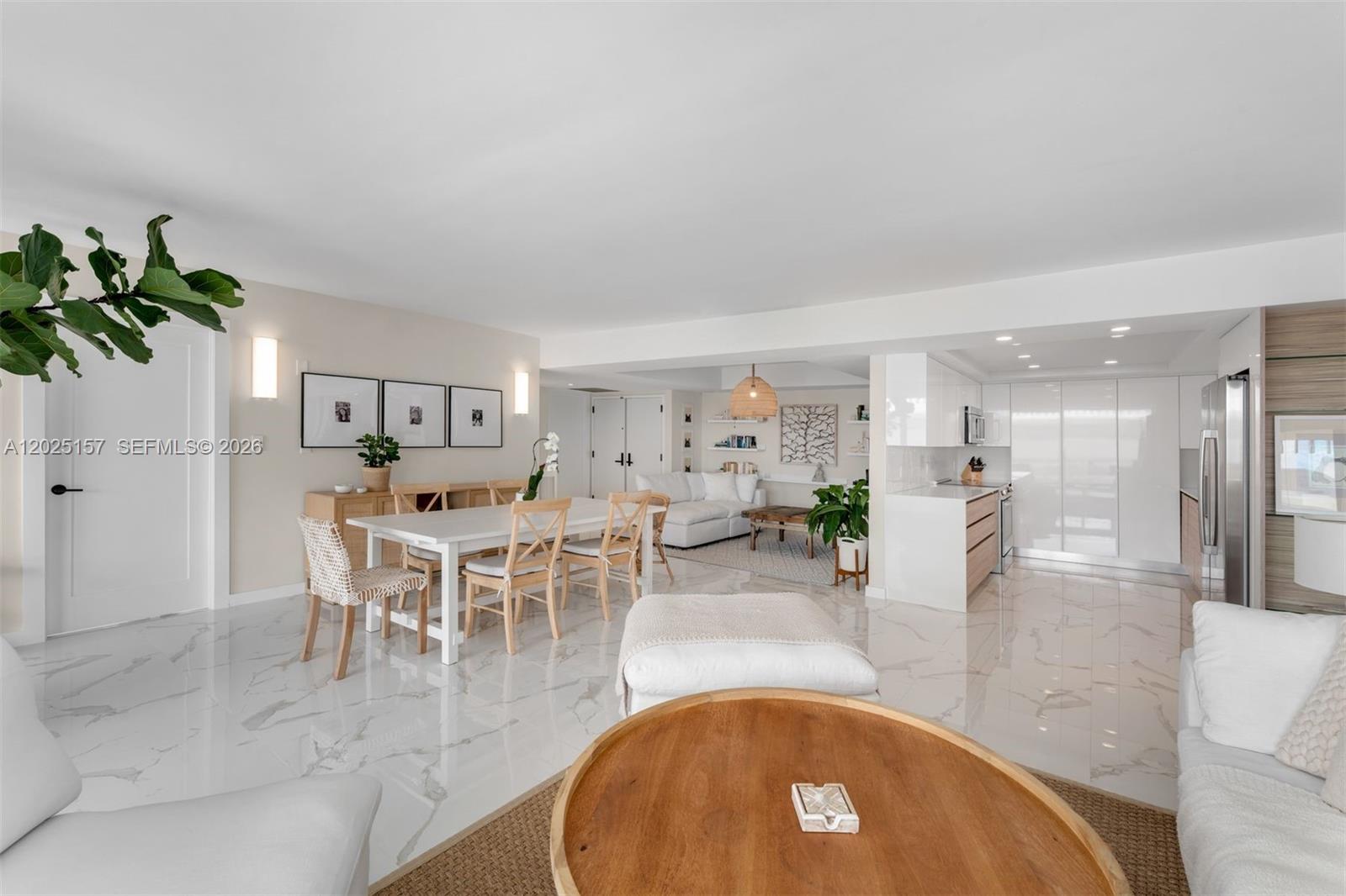 An open-concept living and dining area features white marble floors and a modern kitchen — 3 Grove Isle Dr # C803, Miami FL 33133, MIAMI, FL