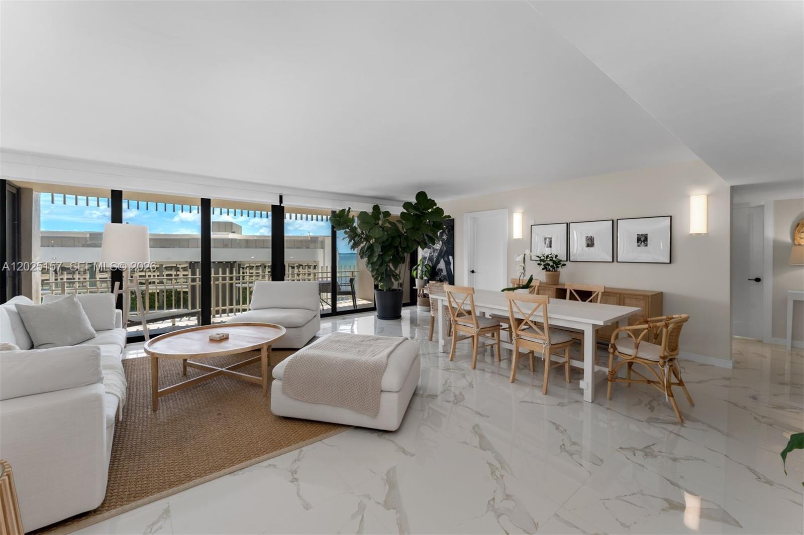 A bright, open-concept living and dining area features white marble floors and floor-to-ceiling windows — 3 Grove Isle Dr # C803, Miami FL 33133, MIAMI, FL