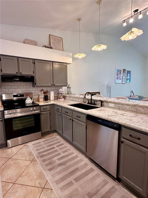 A kitchen features gray cabinets, granite countertops, stainless steel appliances, and a tile floor — 824 NW 124TH DRIVE, NEWBERRY, FL