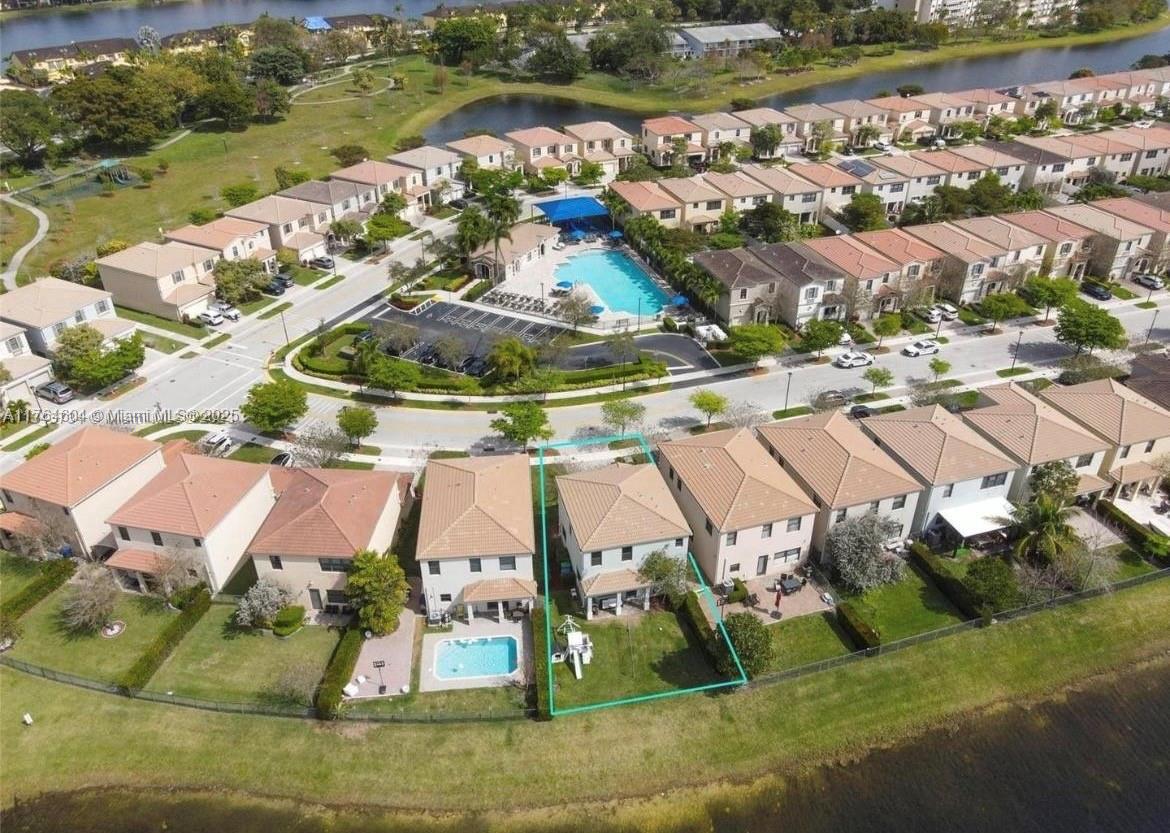 An aerial view shows a residential neighborhood with a highlighted house featuring a backyard lawn — 616 NE 193rd St, Miami FL 33179, MIAMI, FL