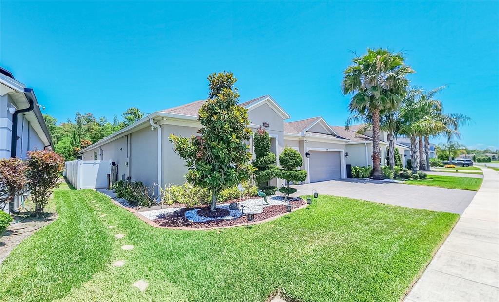 A single-story house with a manicured lawn, landscaping, and a two-car garage — 2389 PEARL CIDER STREET, ORLANDO, FL