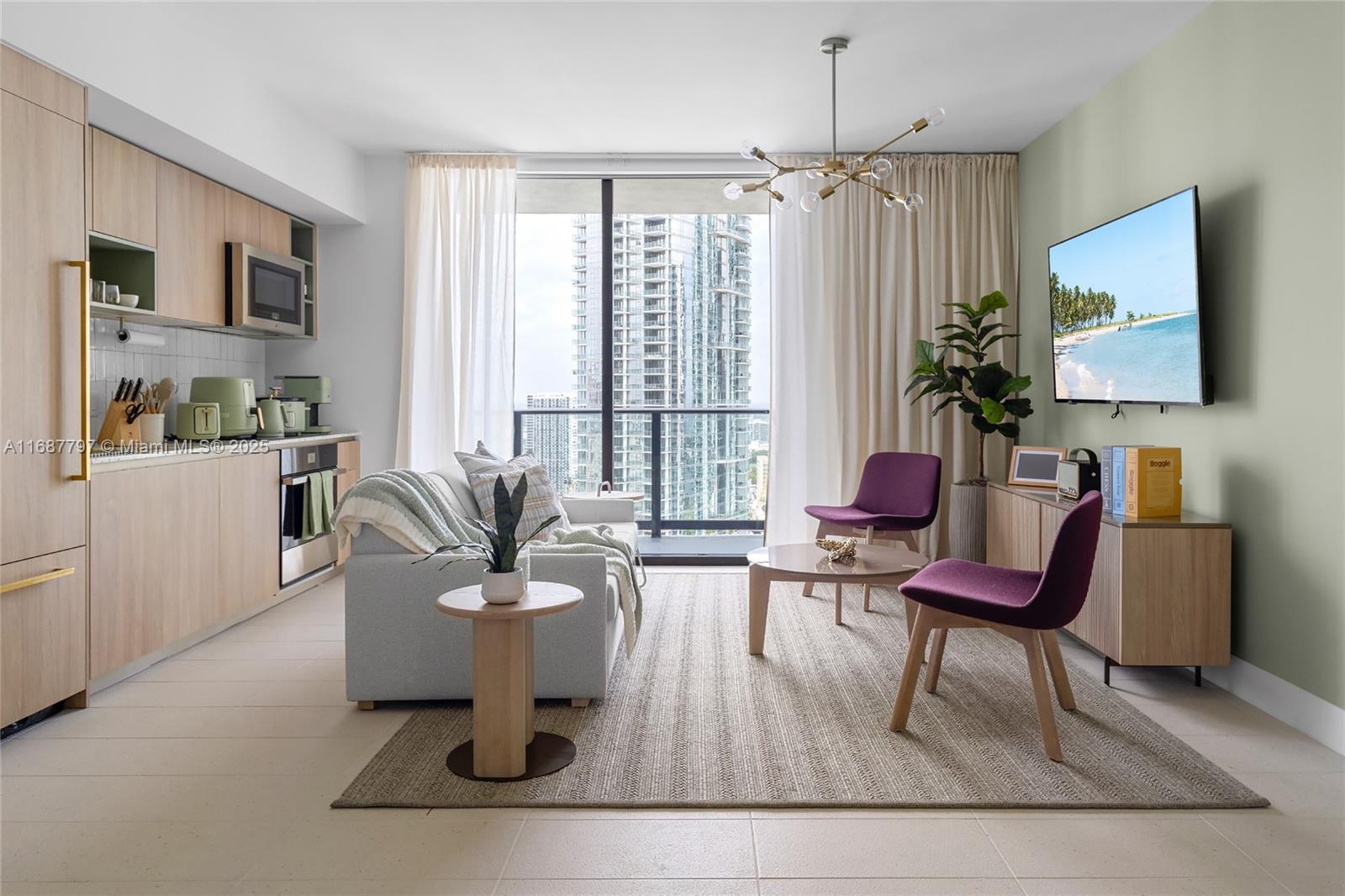 A modern studio apartment features a kitchen, living area, and floor-to-ceiling windows overlooking city buildings — 159 NE 6TH ST # 3002, Miami FL 33132, MIAMI, FL