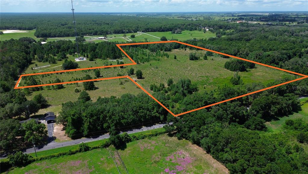 An aerial view shows a large, irregularly shaped plot of land outlined in orange — SW 41ST PLACE, OCALA, FL