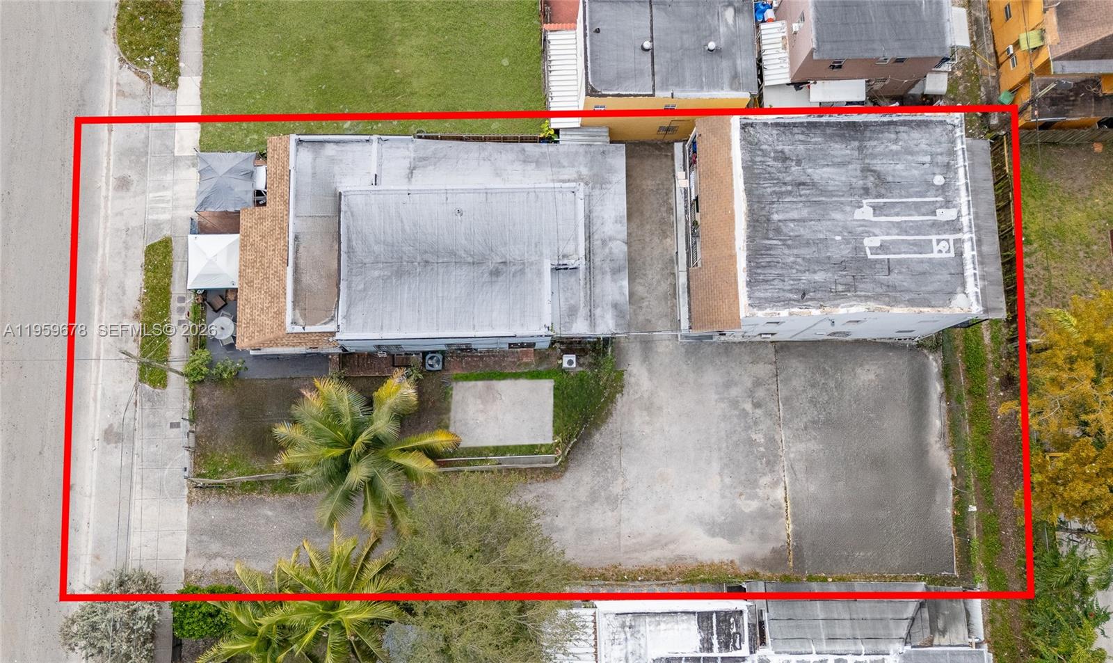An aerial view shows two buildings on a lot with a large paved parking area — 2616 NW 23rd Ave, Miami FL 33142, MIAMI, FL