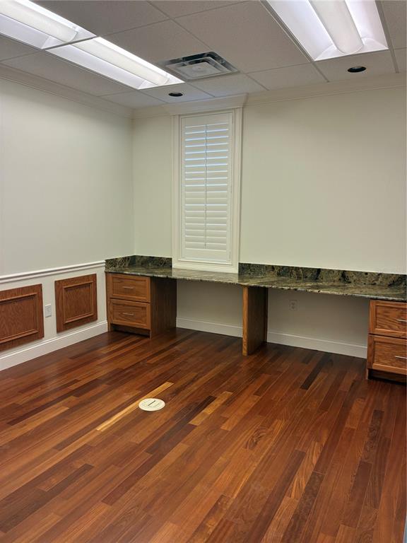 An office with hardwood floors, built-in wooden desks with granite countertops, and plantation shutters — 1350 CITY VIEW CENTER, OVIEDO, FL