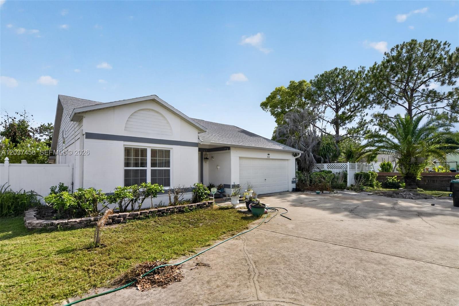 A single-story house with a white exterior, a two-car garage, and a concrete driveway — 362 WHITE MARSH CIRCLE, Orlando FL 32824, ORLANDO, FL