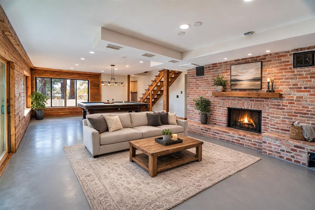 A living room features a brick fireplace, a pool table, and wood-paneled walls — 123 MASON LAKE TRAIL, HAWTHORNE, FL