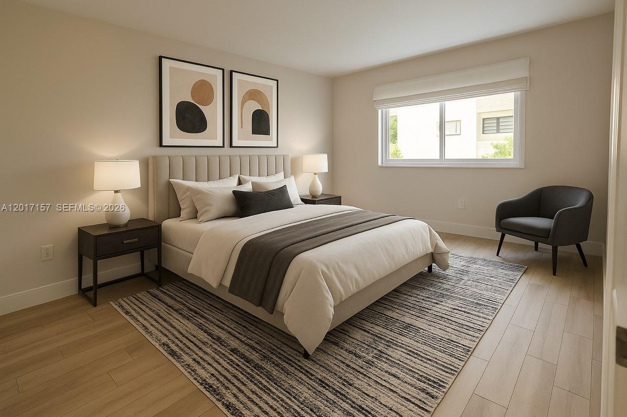 A bedroom features a bed with a neutral headboard, two nightstands, and a gray chair — 50 Ocean Lane Dr # 404, Key Biscayne FL 33149, KEY BISCAYNE, FL