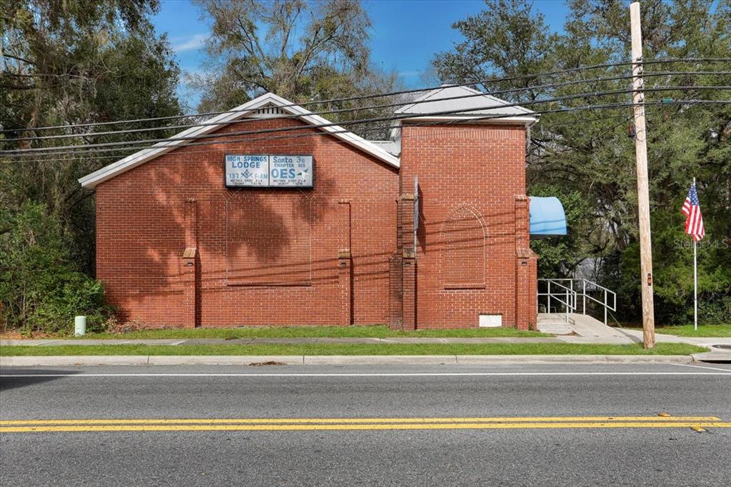 A red brick building with a sign for a Masonic lodge stands beside a road — 18616 NW 241ST STREET, HIGH SPRINGS, FL