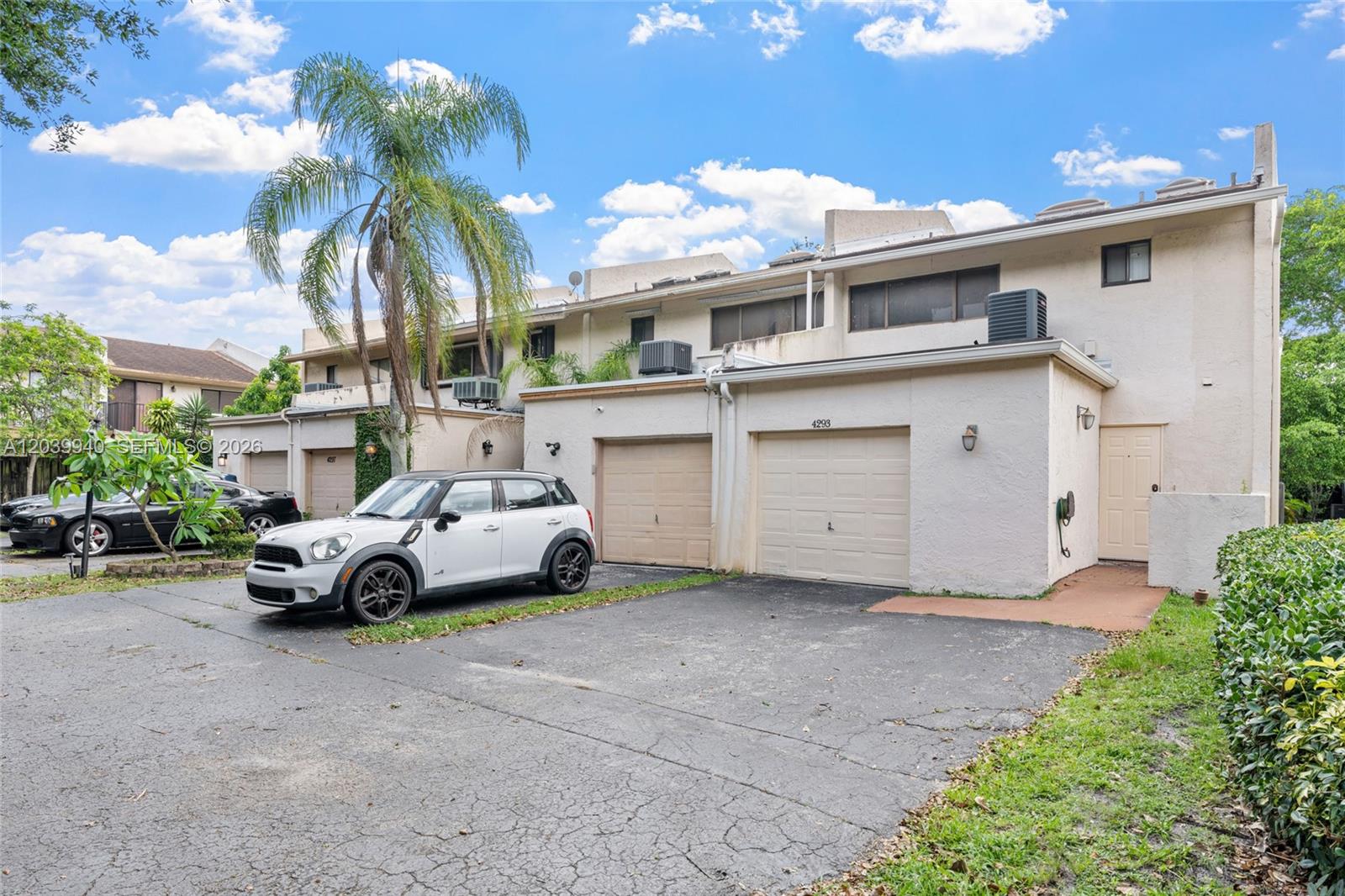 A white Mini Cooper is parked in the driveway of a two-story townhouse complex — 4293 N 76th Ave, Davie FL 33024, DAVIE, FL