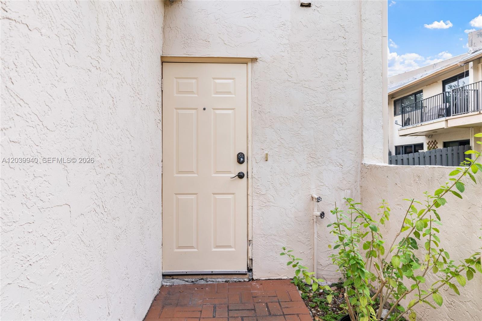 A beige exterior door with a keypad lock sits on a brick patio — 4293 N 76th Ave, Davie FL 33024, DAVIE, FL