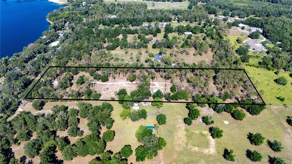 An aerial view shows a large, rectangular plot of land outlined in black — 0 REED ROAD, DADE CITY, FL