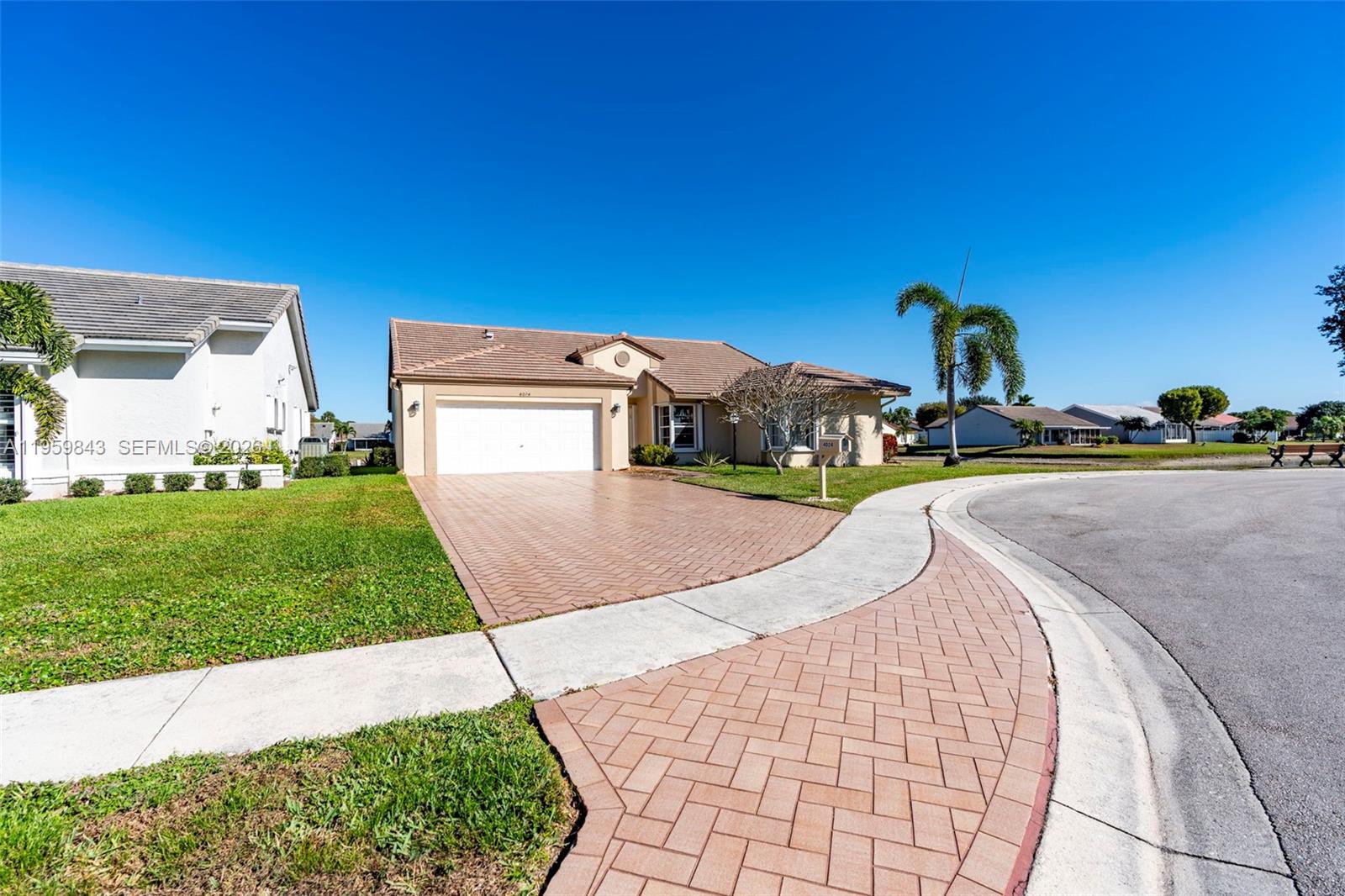 A single-story house with a tiled roof, a paved driveway, and a manicured lawn — 4024 Summer Chase Ct, Lake Worth FL 33467, LAKE WORTH, FL