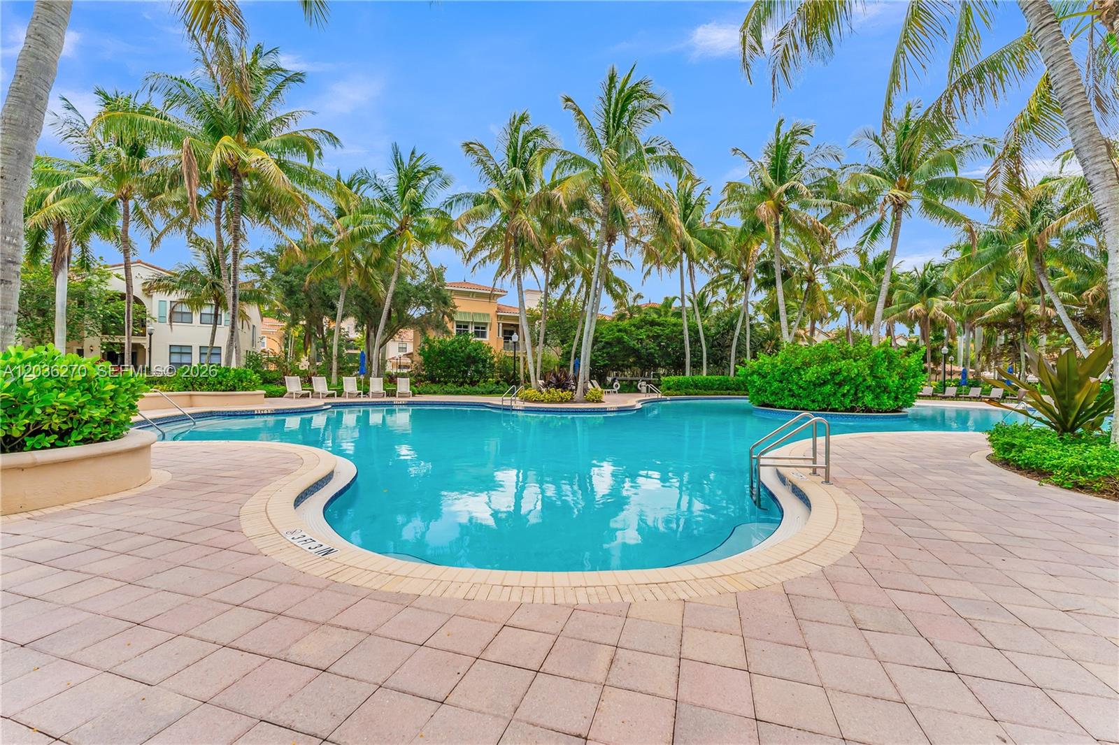 A swimming pool surrounded by palm trees and a paved deck with lounge chairs — 2925 NW 126th Ave # 1, Sunrise FL 33323, SUNRISE, FL