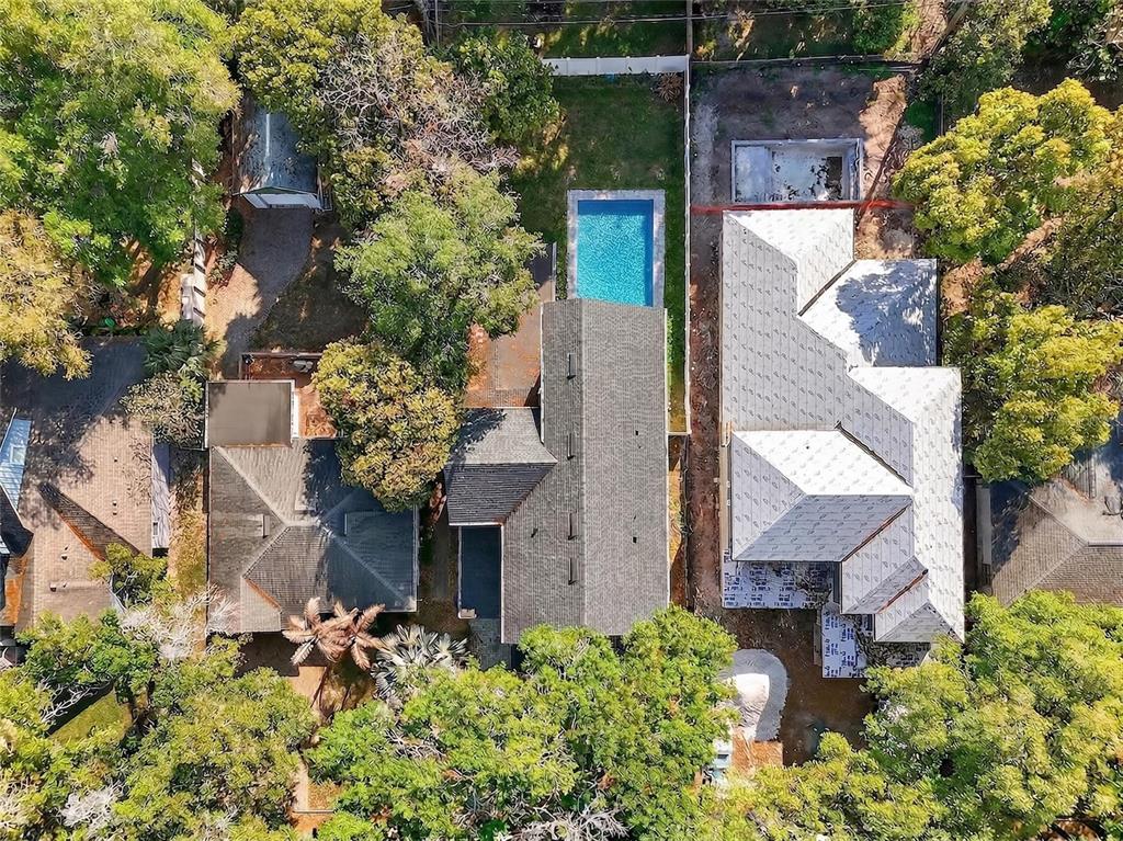 An aerial view shows three adjacent residential properties with trees, a swimming pool, and construction — 2935 HELEN AVENUE, ORLANDO, FL