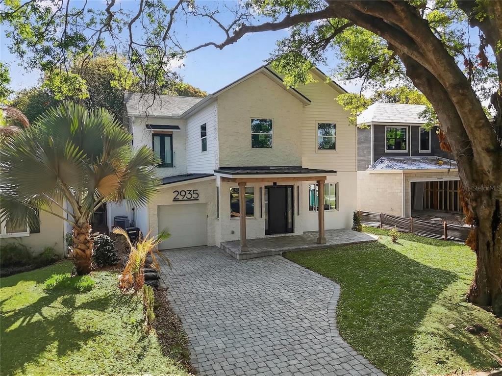 A two-story house with a brick facade, a paved driveway, and a covered front porch — 2935 HELEN AVENUE, ORLANDO, FL