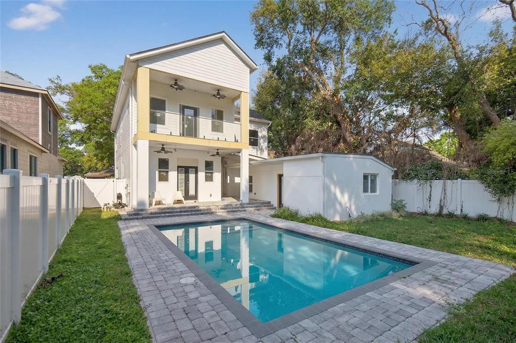 A two-story house with a balcony, a swimming pool, and a white fence in back — 2935 HELEN AVENUE, ORLANDO, FL