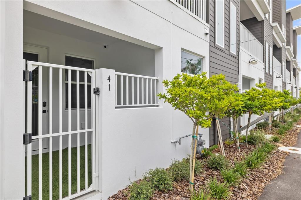 A white gate leads to a patio entrance marked with the number 41 — 41 29TH STREET N, ST PETERSBURG, FL