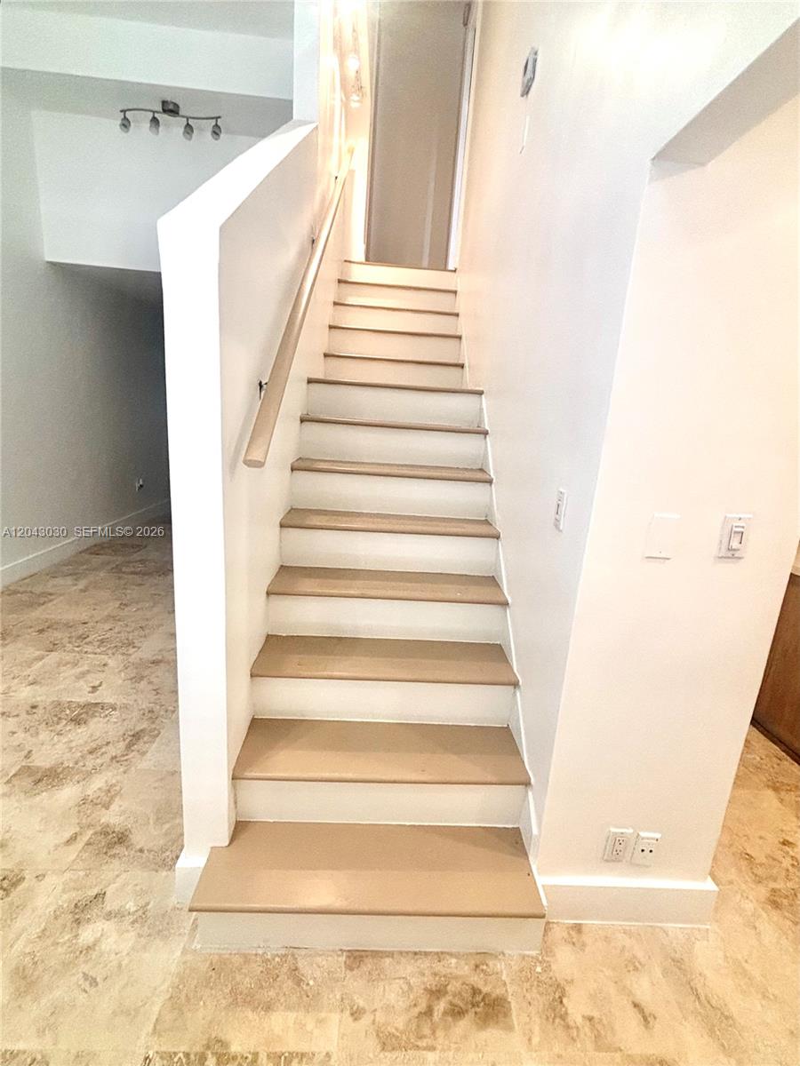 A straight staircase with tan treads and white risers leads to an upper landing — 2666 Tigertail Ave # 114, Miami FL 33133, MIAMI, FL