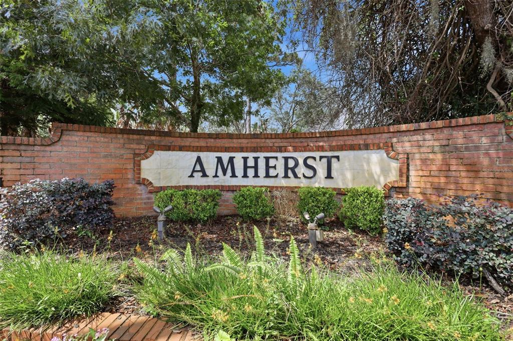 A brick wall features a sign reading Amherst in front of trees and landscaping — 1055 CHESTERFIELD CIRCLE, WINTER SPRINGS, FL