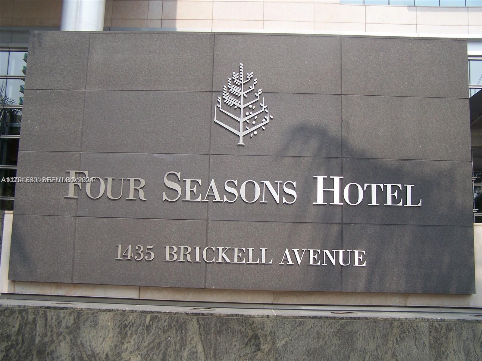 A dark stone wall displays the silver Four Seasons Hotel logo and lettering — 1435 Brickell Ave # 3307, Miami FL 33131, MIAMI, FL