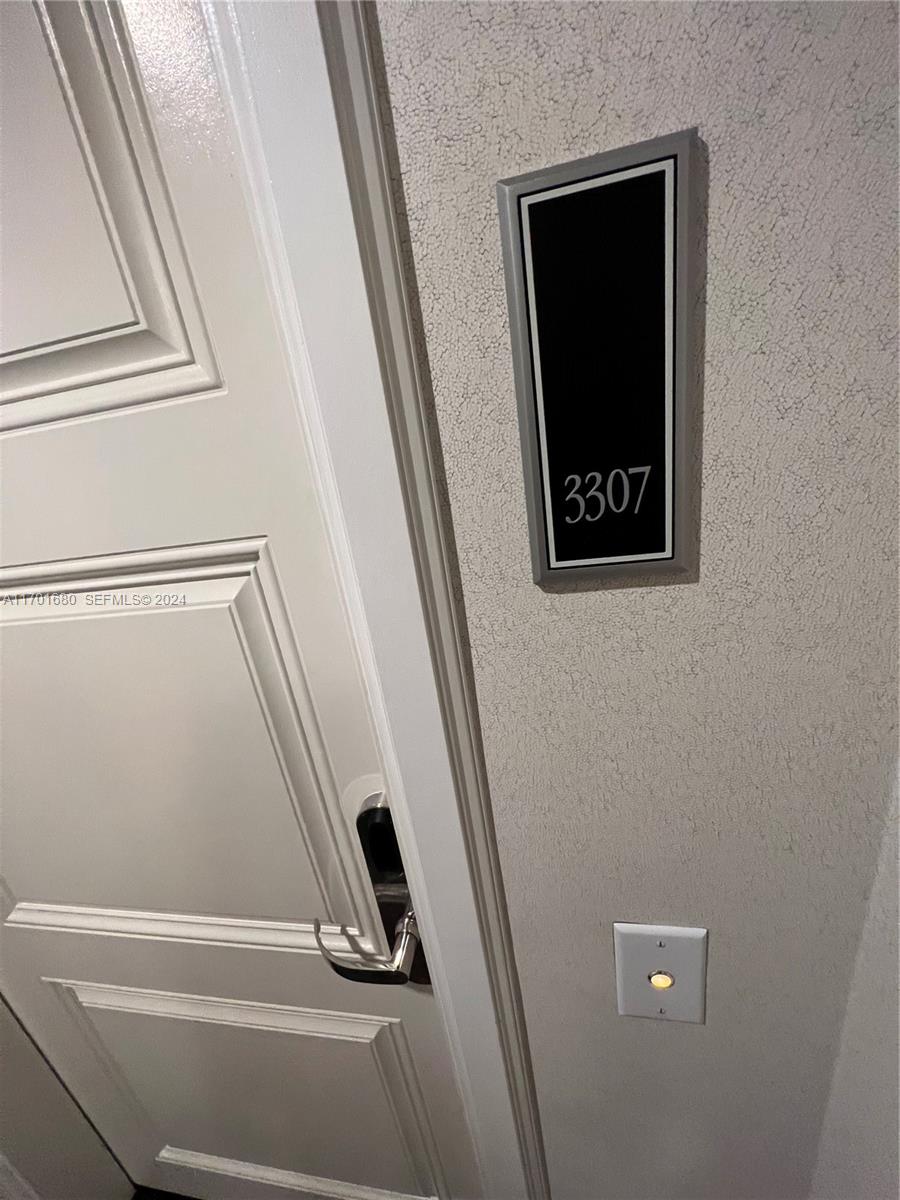 A close-up view shows a white door with a silver handle and room number 3307 — 1435 Brickell Ave # 3307, Miami FL 33131, MIAMI, FL