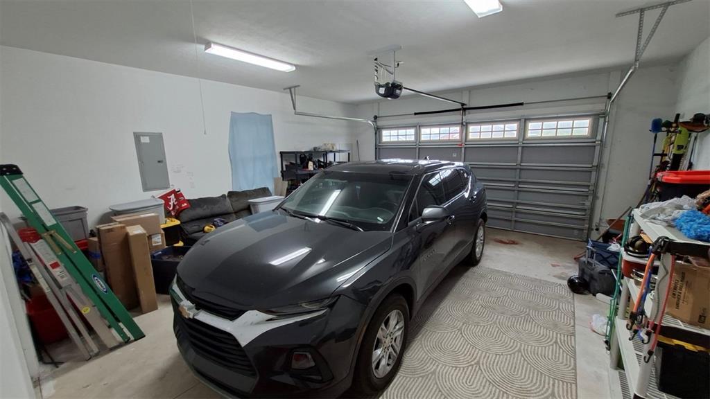 A dark SUV is parked inside a garage with white walls and a concrete floor — 20074 NW 249TH STREET, HIGH SPRINGS, FL