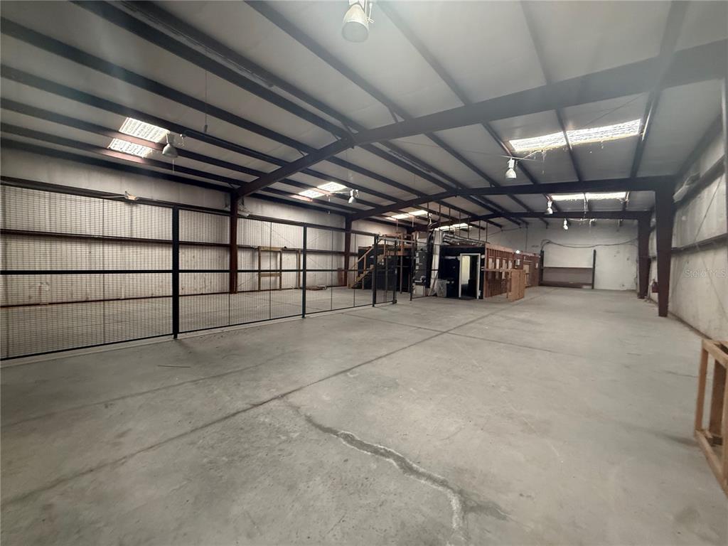 An interior view of a large, open warehouse space with concrete floors and metal framing — 4344 SE 95TH STREET UNIT 2, OCALA, FL