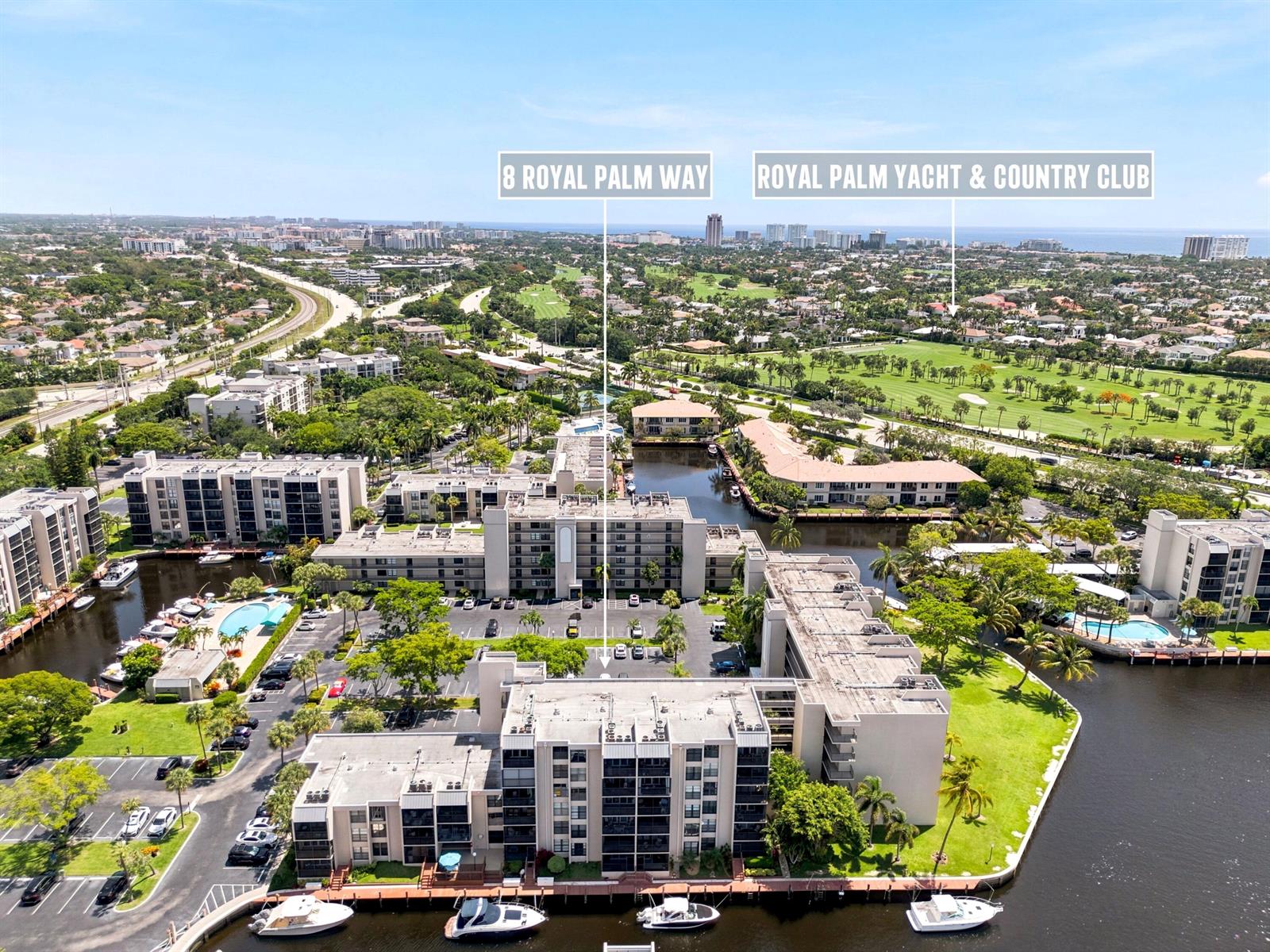An aerial view shows multi-story apartment buildings with a parking lot and boat docks — 8 Royal Palm Way # 3020, Boca Raton FL 33432, BOCA RATON, FL